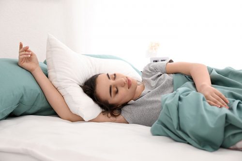 Young beautiful woman sleeping in morning at home